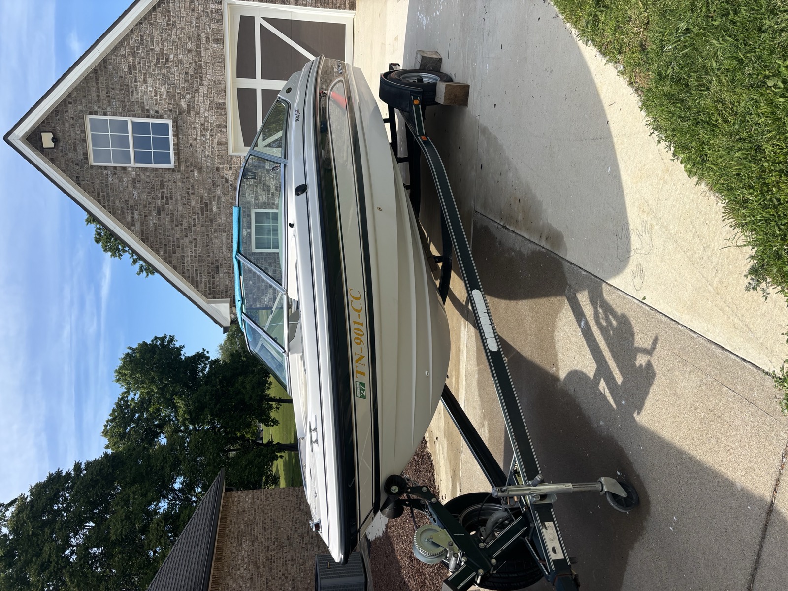 Chaparral bowrider on its trailer after a full exterior boat detail — clean white hull with restored gloss