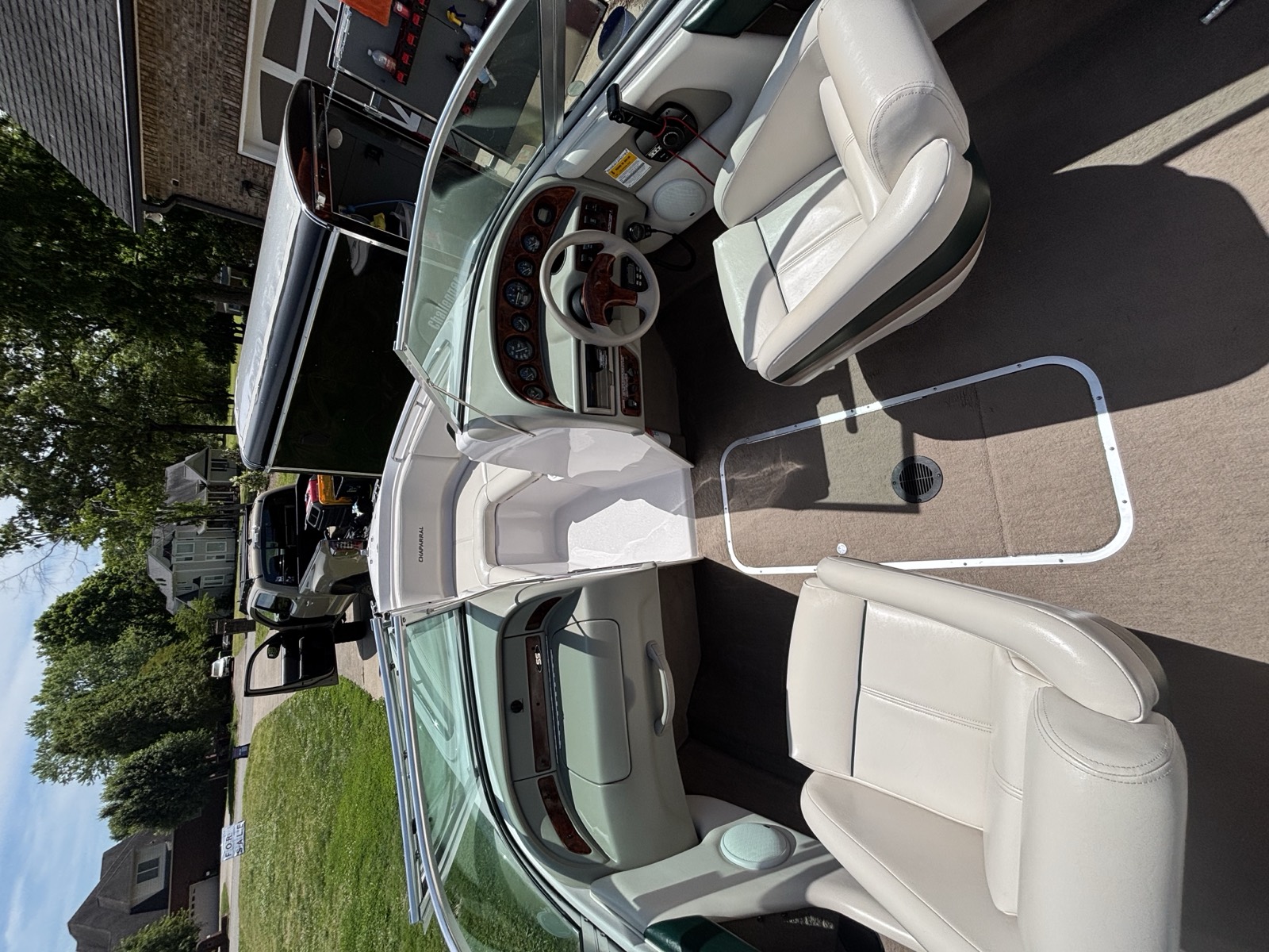 Boat interior after detailing — deep-cleaned white vinyl seating and spotless cockpit