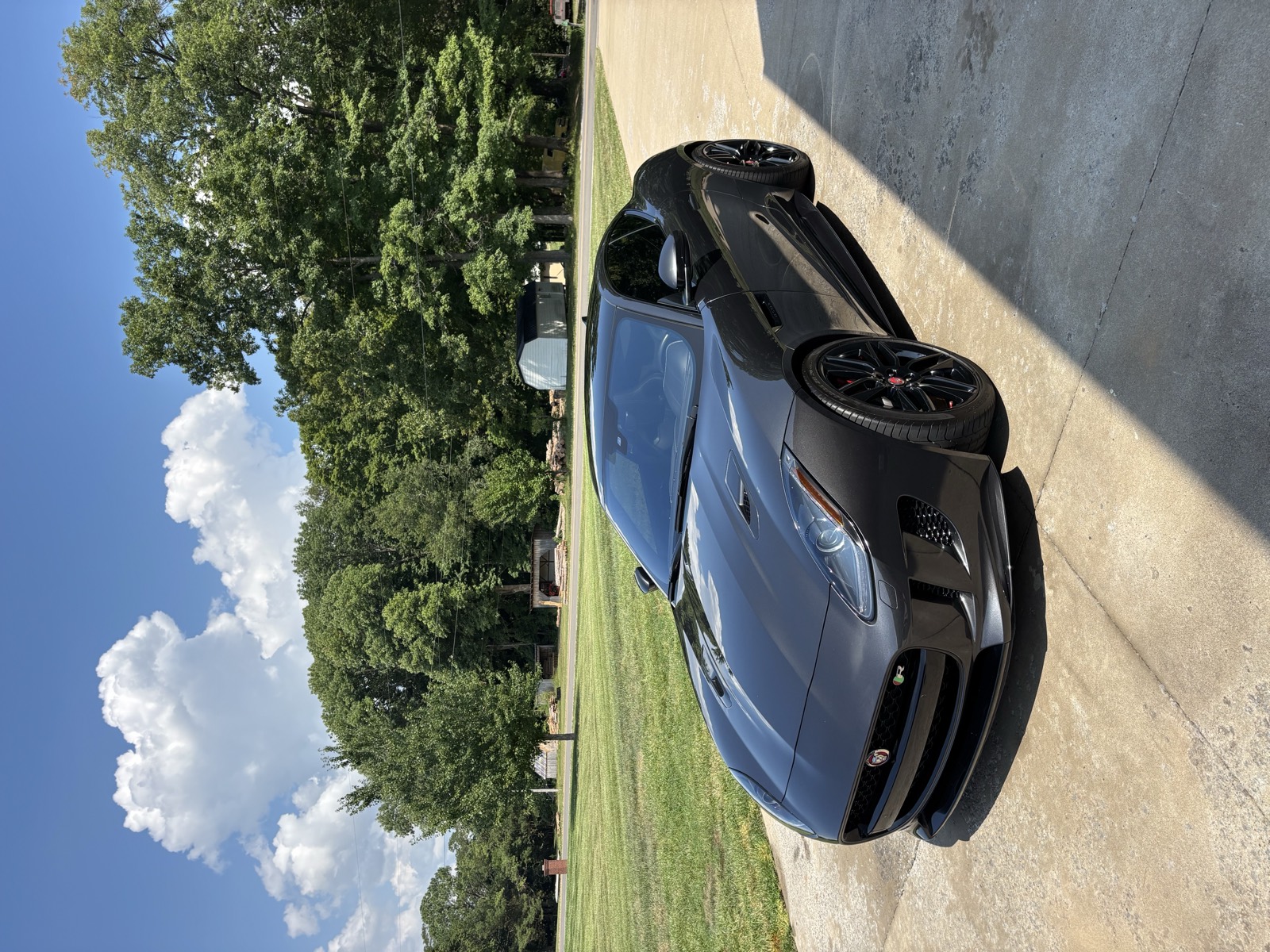 Black Jaguar F-Type with deep, swirl-free paint after machine polishing