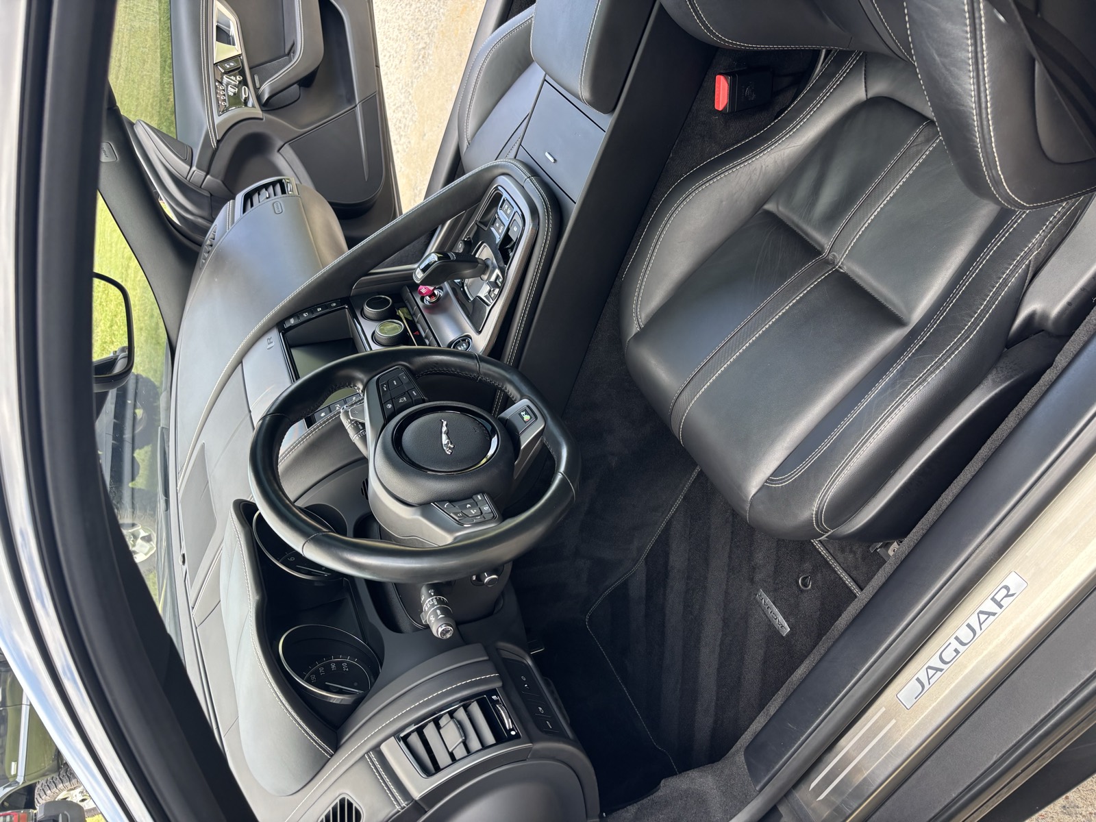 Jaguar interior after full interior detail — clean dashboard, dressed trim, and spotless leather seats