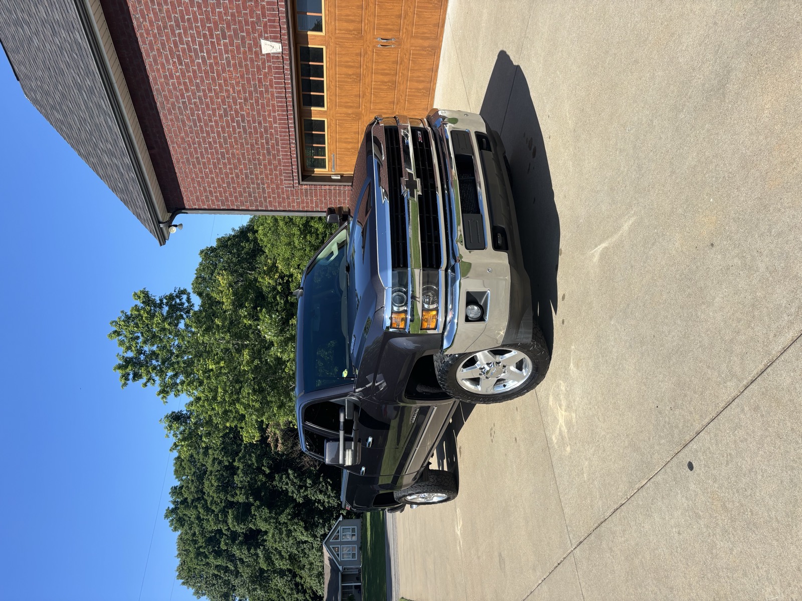 White Chevy Silverado after an exterior detail — glossy paint and clean chrome in a residential driveway