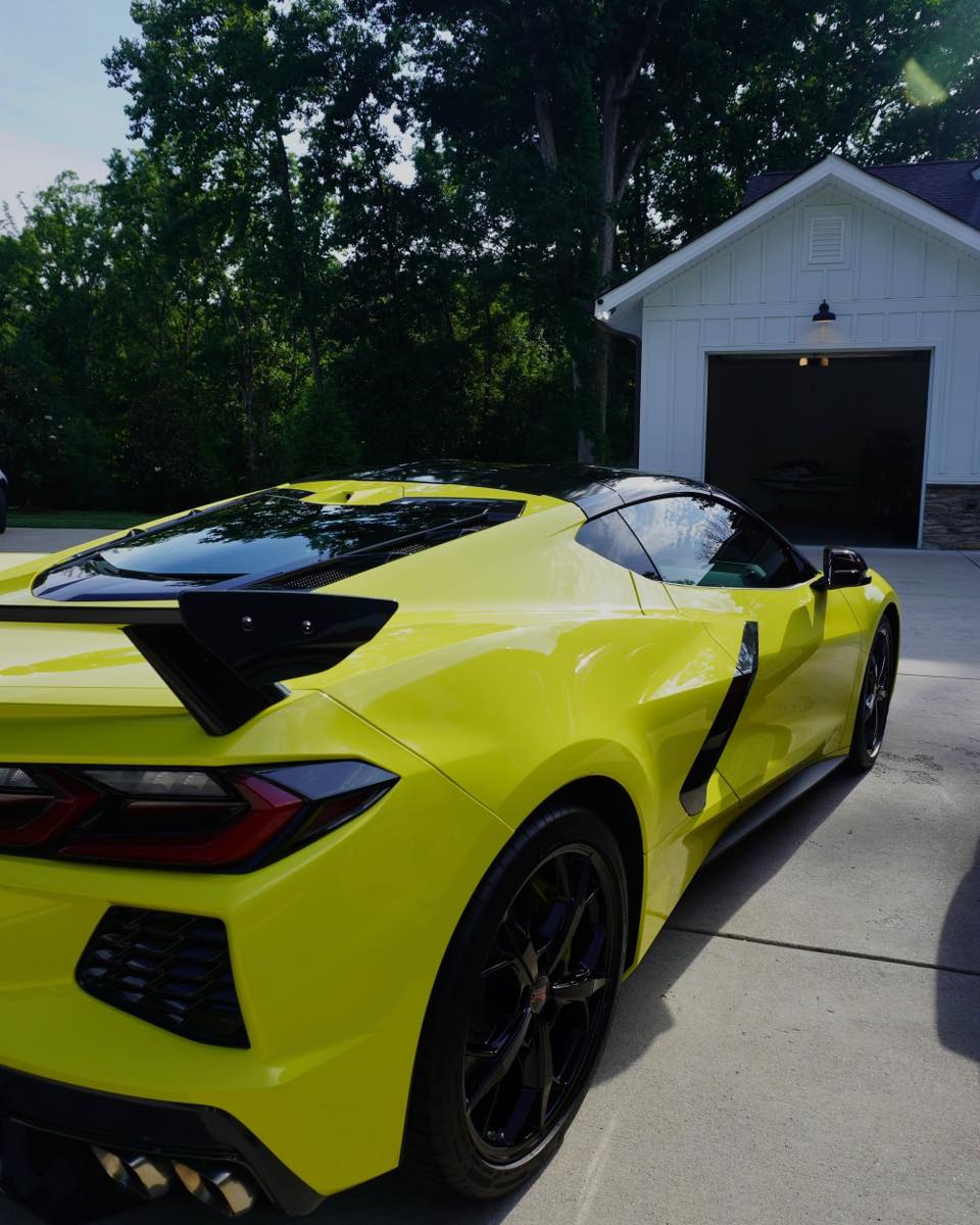 Yellow C8 Corvette rear quarter panel after paint correction — deep gloss finish with flawless clear coat